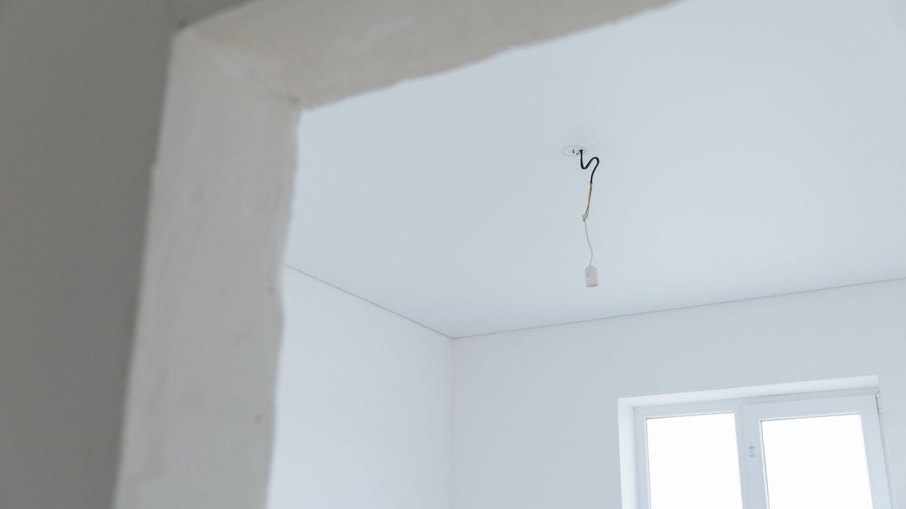 Unfinished lighting wires in a room being renovated